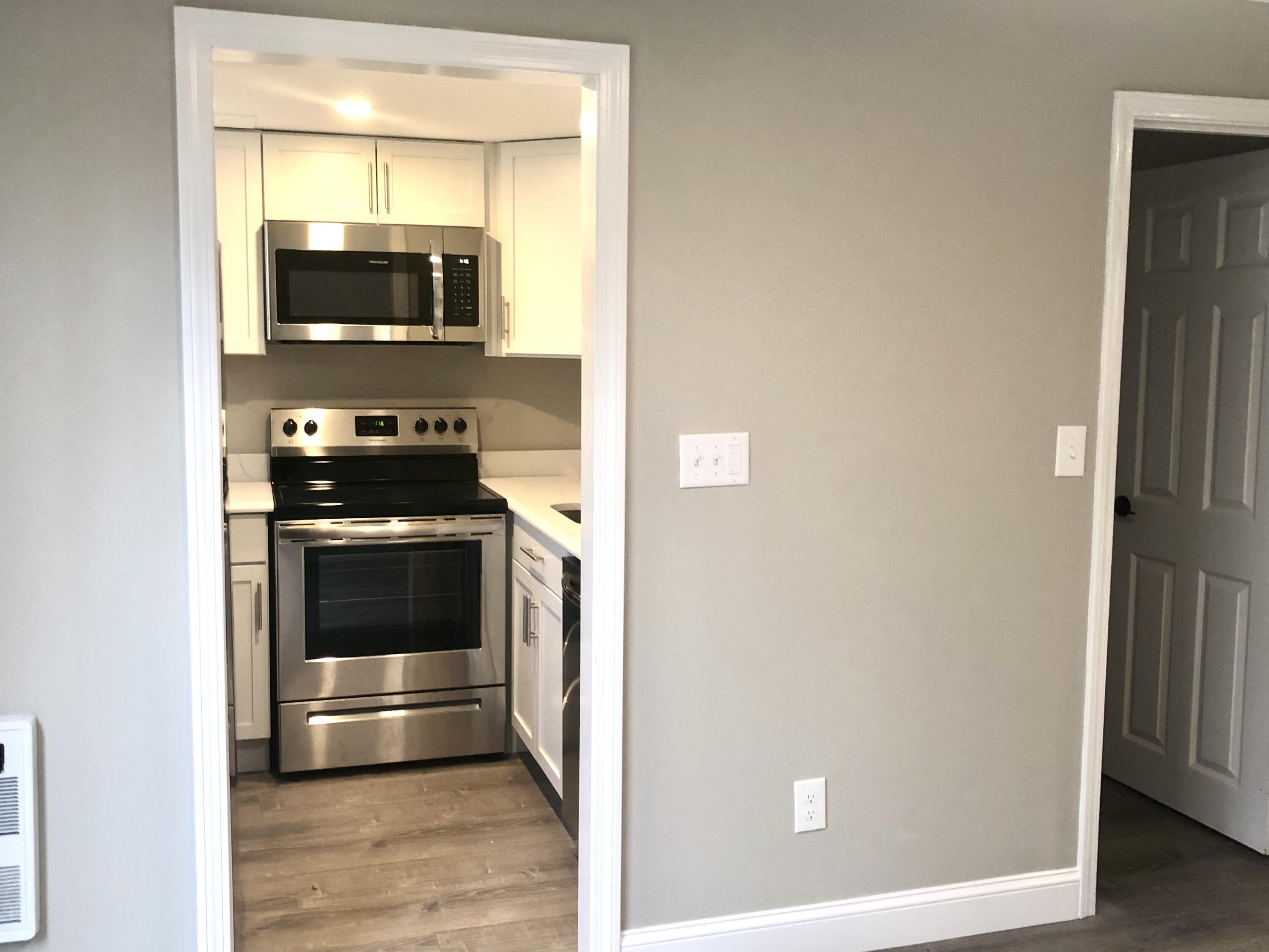 135 West Main Street, Unit 26 Hyannis, MA 02601 - Photo 9 of 29 a kitchen with stainless steel appliances a stove and a microwave