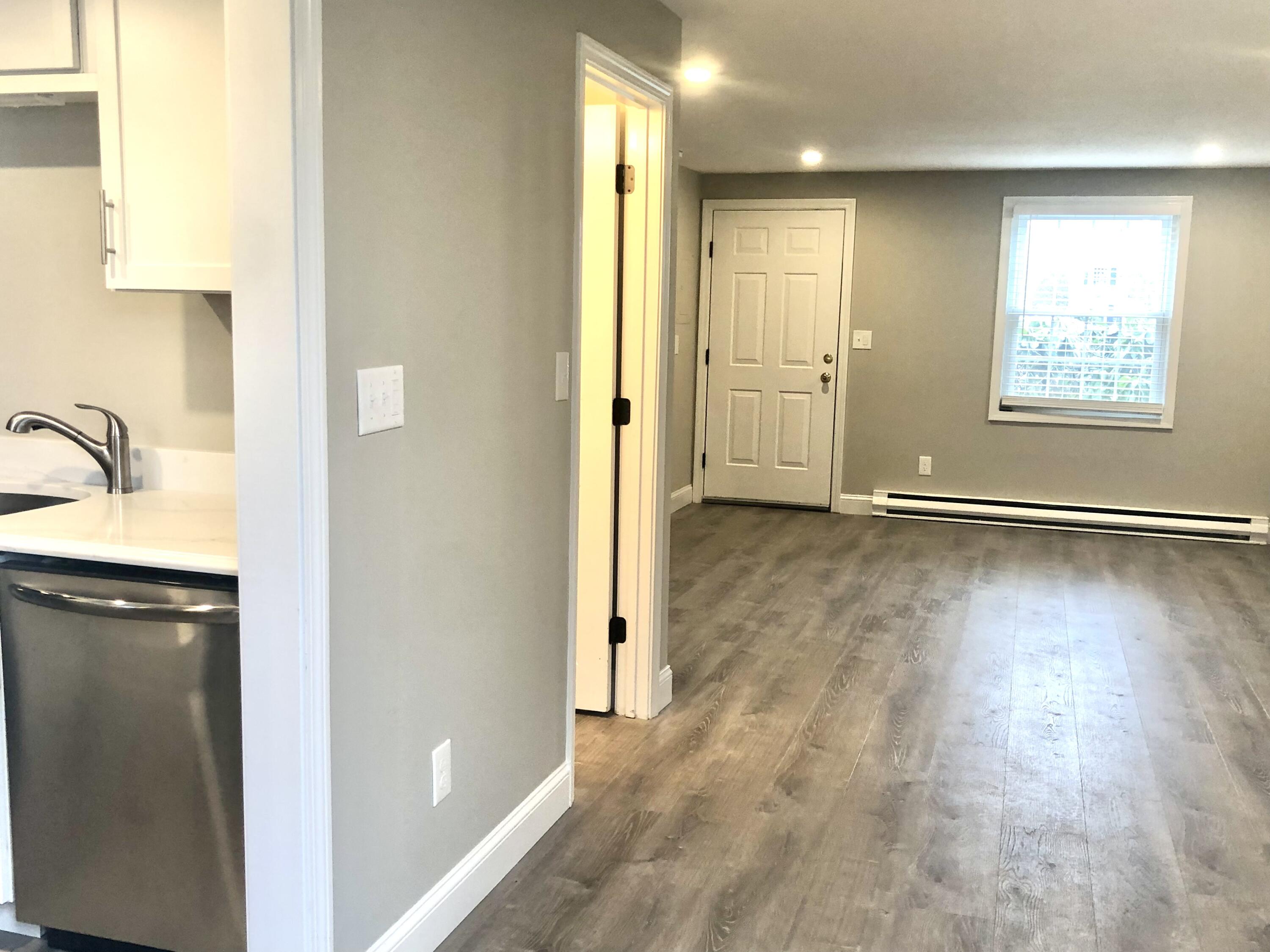 135 West Main Street, Unit 26 Hyannis, MA 02601 - Photo 10 of 29 a view of a hallway with wooden floor and cabinet