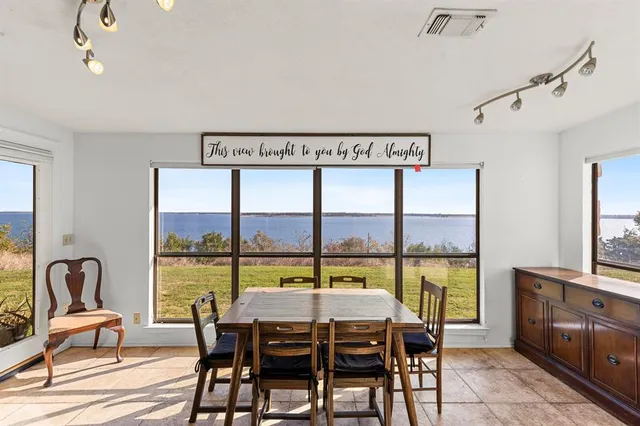 a dining room with furniture and a window