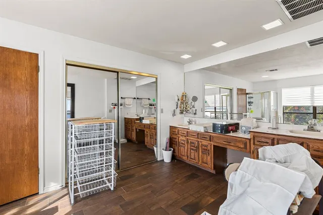 a large kitchen with lot of cabinets and stainless steel appliances