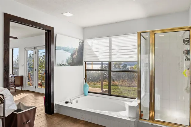 a bathroom with a tub and shower