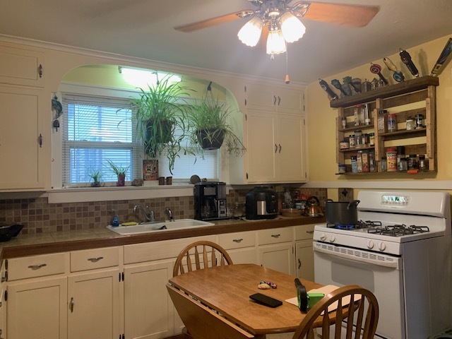 1013 Guion Street Ottawa, IL 61350 - Photo 11 of 26 a kitchen with a stove a sink and a refrigerator