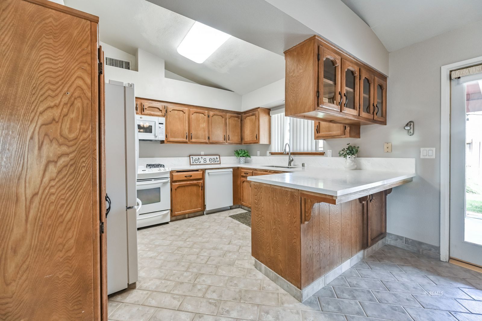 131 Chambers Street Ridgecrest, CA 93555 - Photo 3 of 28 a kitchen with stainless steel appliances granite countertop a stove top oven sink and cabinets