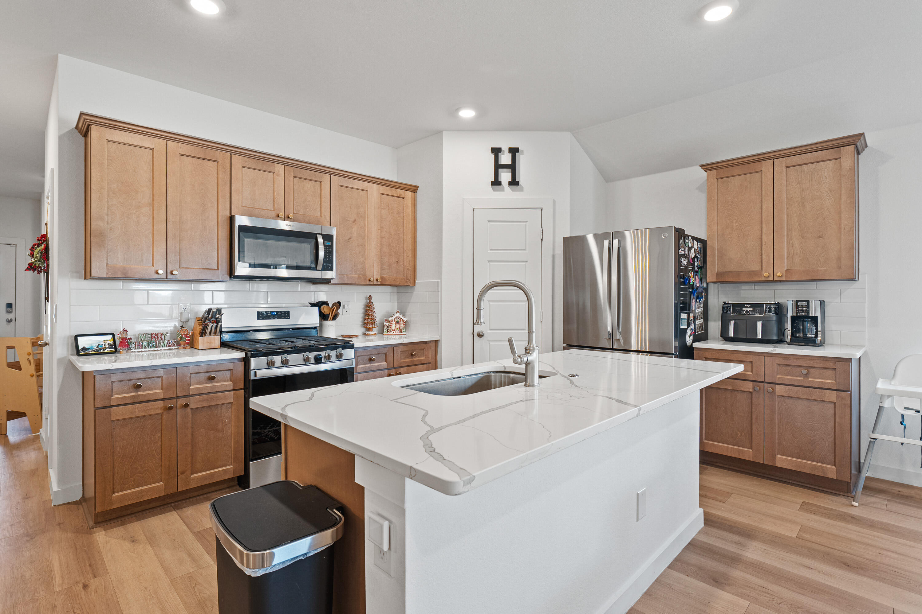 10517 Bangor Avenue Lubbock, TX 79424 - Photo 12 of 27 a kitchen with stainless steel appliances granite countertop a stove a sink a refrigerator and a microwave