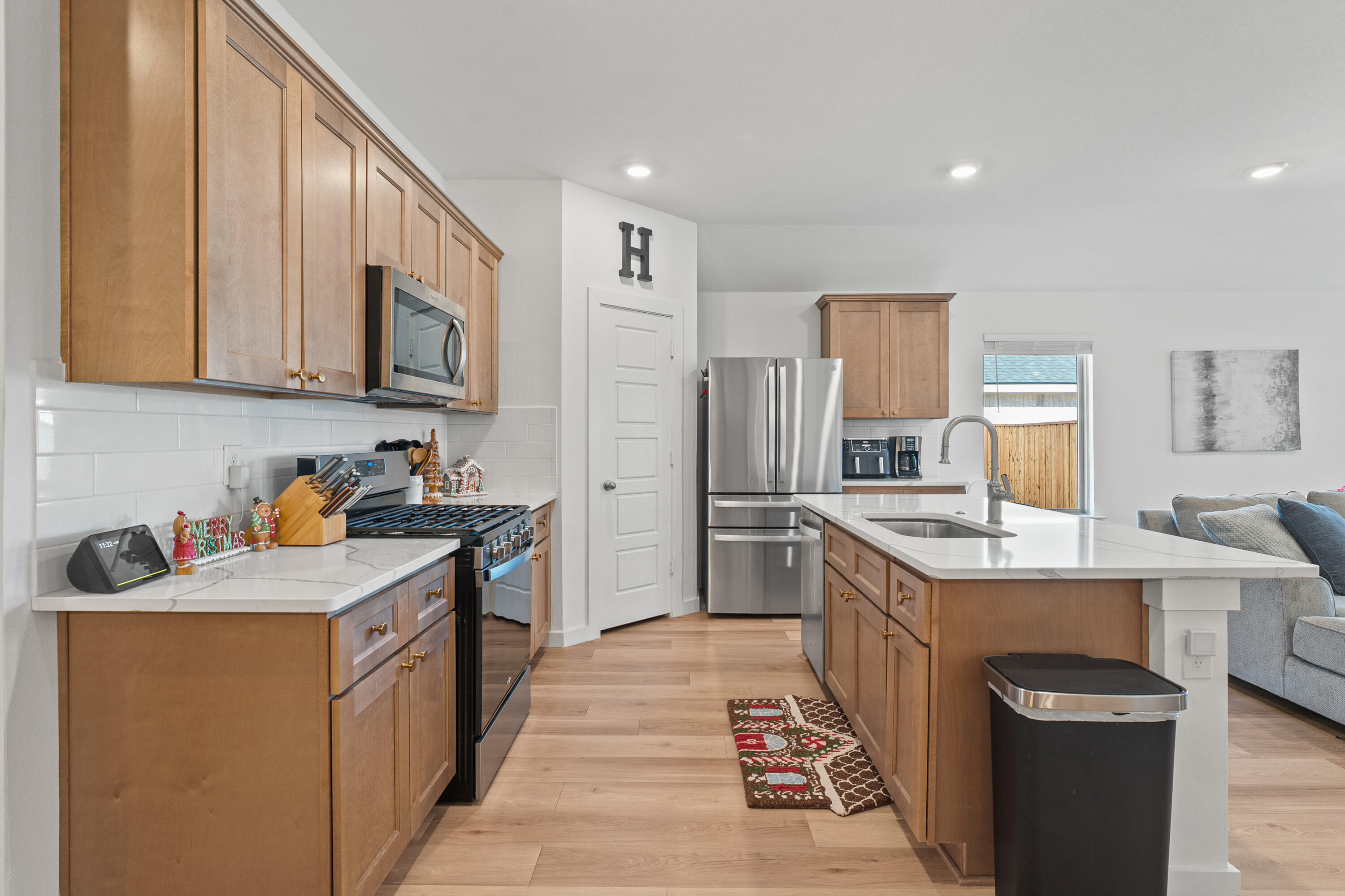 10517 Bangor Avenue Lubbock, TX 79424 - Photo 13 of 27 a kitchen with stainless steel appliances granite countertop a sink stove refrigerator and cabinets