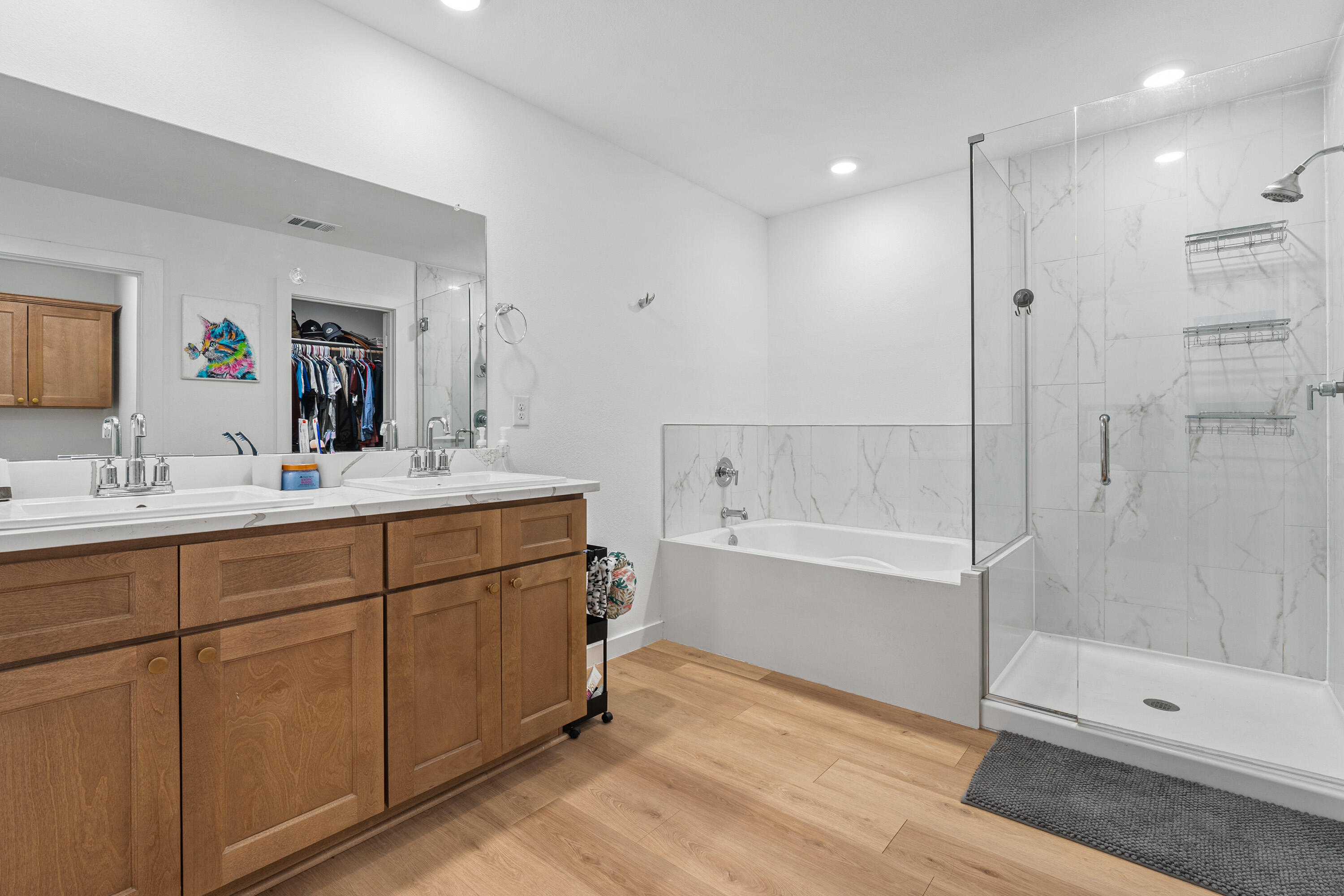 10517 Bangor Avenue Lubbock, TX 79424 - Photo 17 of 27 a bathroom with a bathtub shower sink vanity and mirror