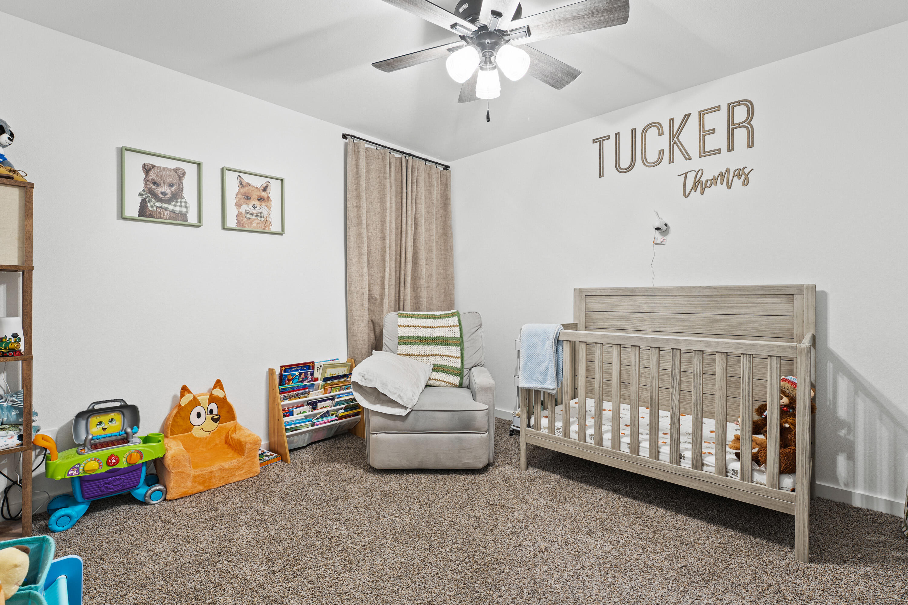 10517 Bangor Avenue Lubbock, TX 79424 - Photo 24 of 27 a bedroom with a bed and a chandelier