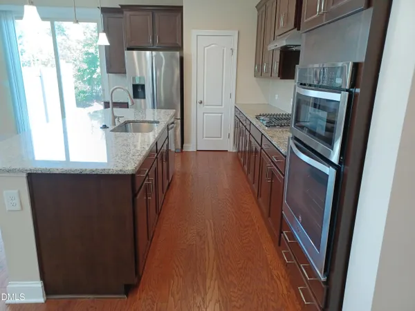 a kitchen with counter top space and stainless steel appliances