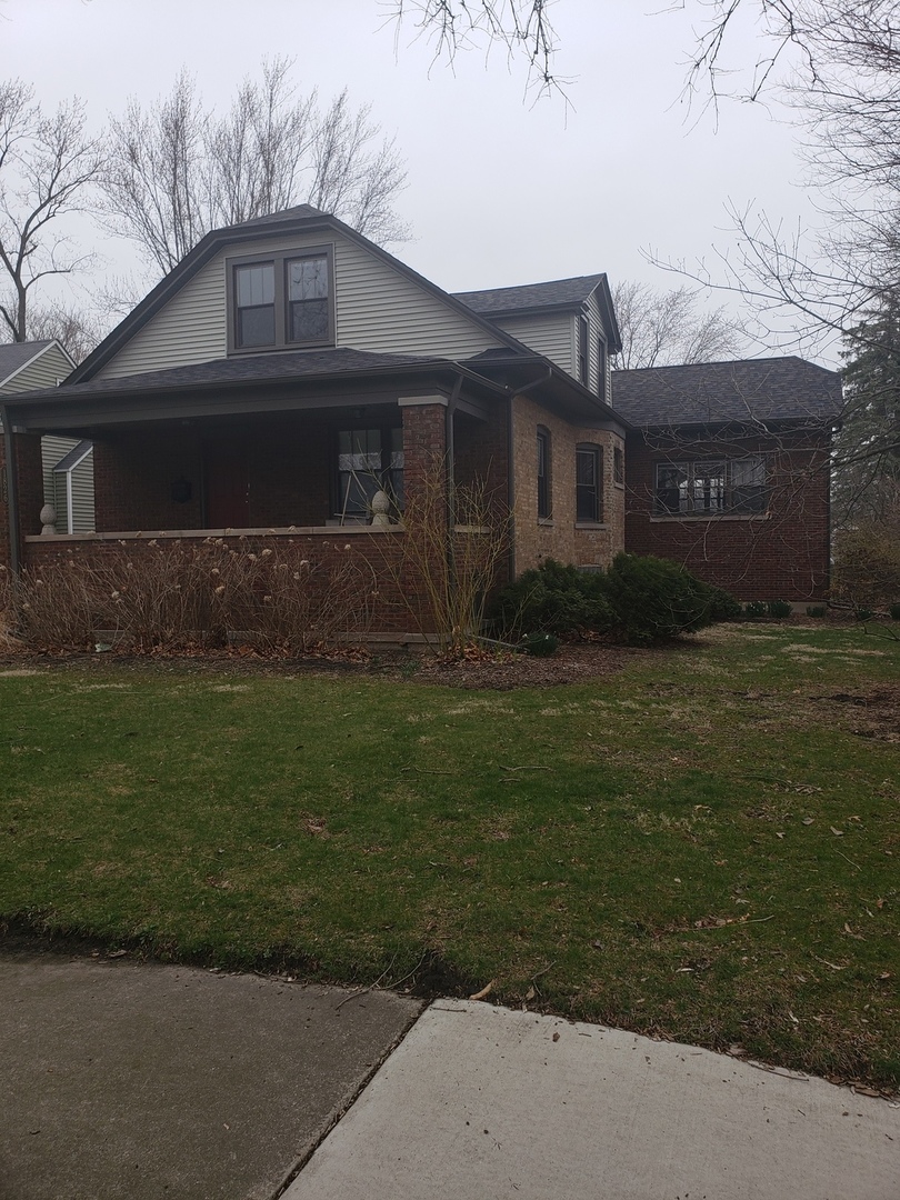 1826 Cedar Road Homewood, IL 60430 - Photo 1 of 1 a front view of a house with a garden