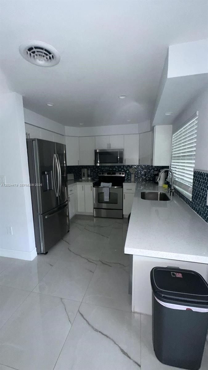 2212 Club House Road North Fort Myers, FL 33917 - Photo 12 of 40 a kitchen with a sink and a stove top oven