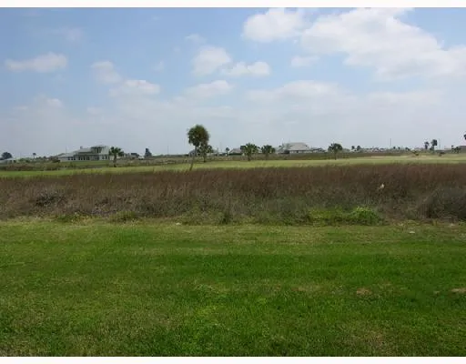 a view of a lake with houses in the back