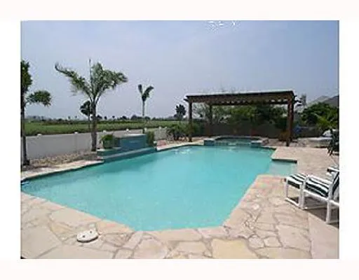 a view of a backyard with a table and chairs