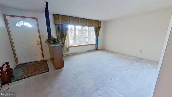 an empty room with windows and closet