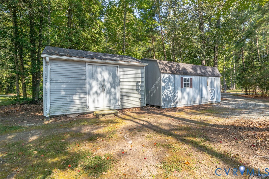 529 Morattico Creek Road Farnham, VA 22460 - Photo 18 of 24 a backyard of a house with large trees and wooden fence