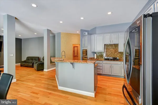 a kitchen with stainless steel appliances a refrigerator a stove top oven and sink