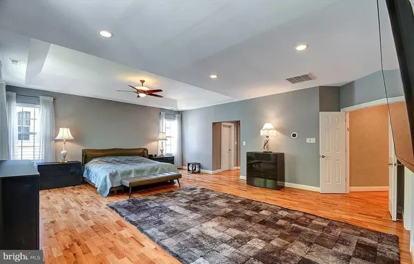 a living room with furniture and a ceiling fan