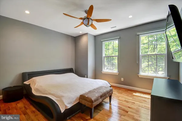 a bedroom with a bed and a ceiling fan