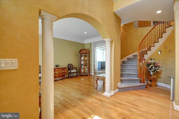 a view of a hallway with wooden floor and staircase