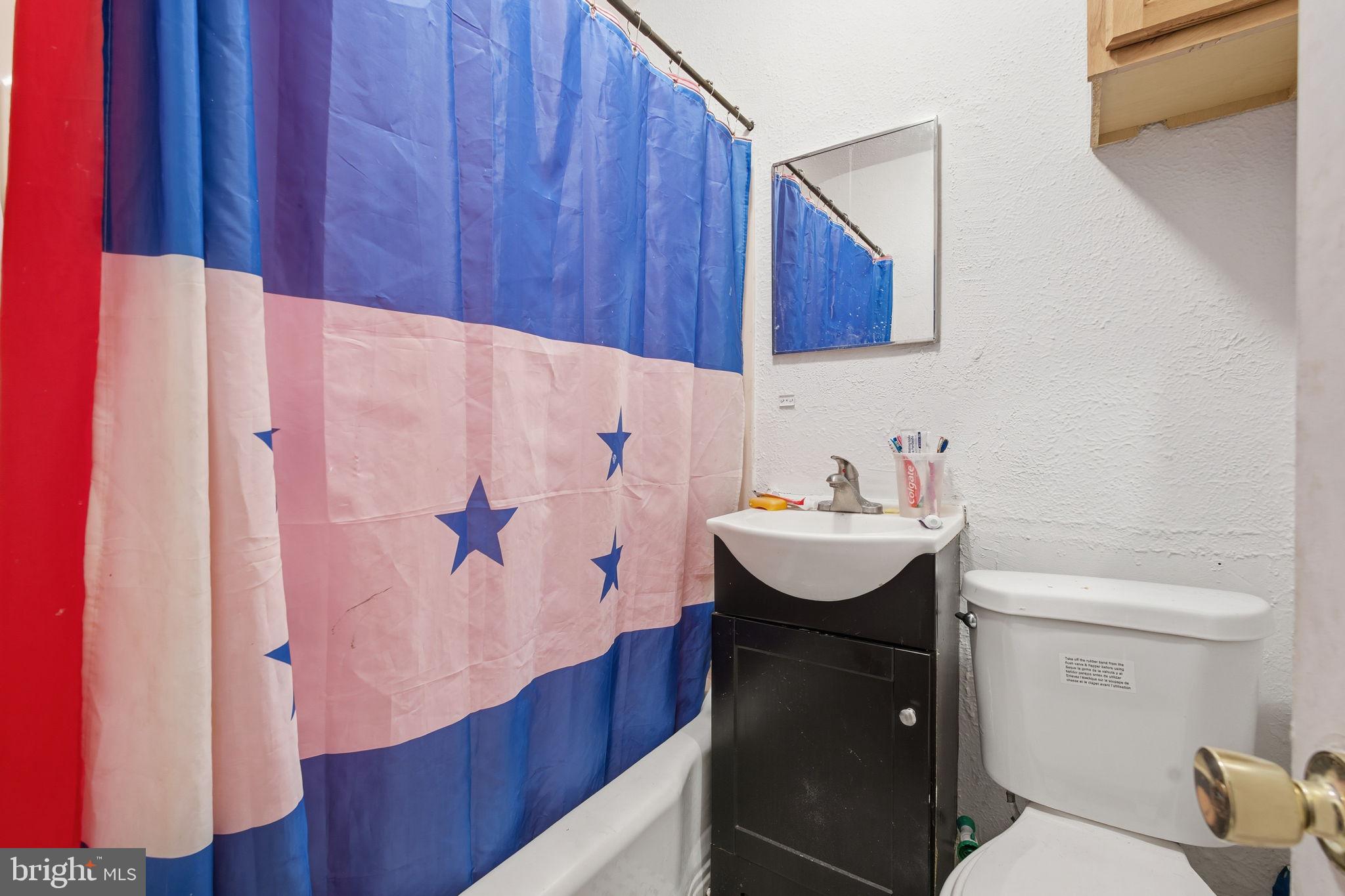3928 8th Street Baltimore, MD 21225 - Photo 13 of 20 a bathroom with a sink toilet and shower
