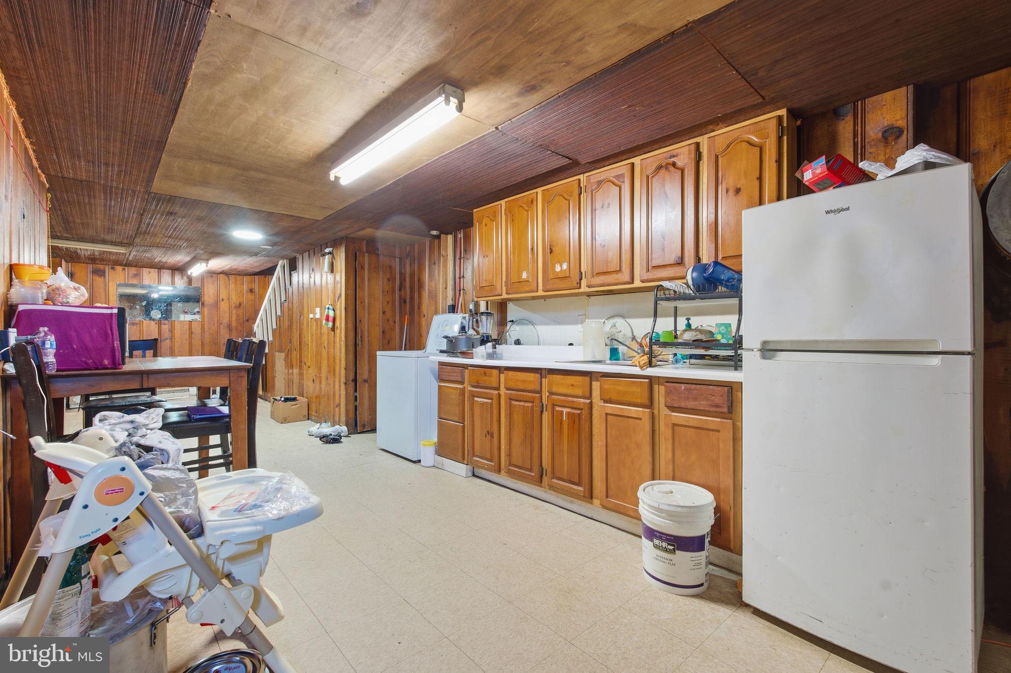 3928 8th Street Baltimore, MD 21225 - Photo 17 of 20 a kitchen with refrigerator and cabinets
