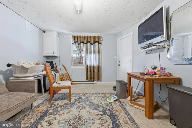 a view of a livingroom with furniture and a flat screen tv