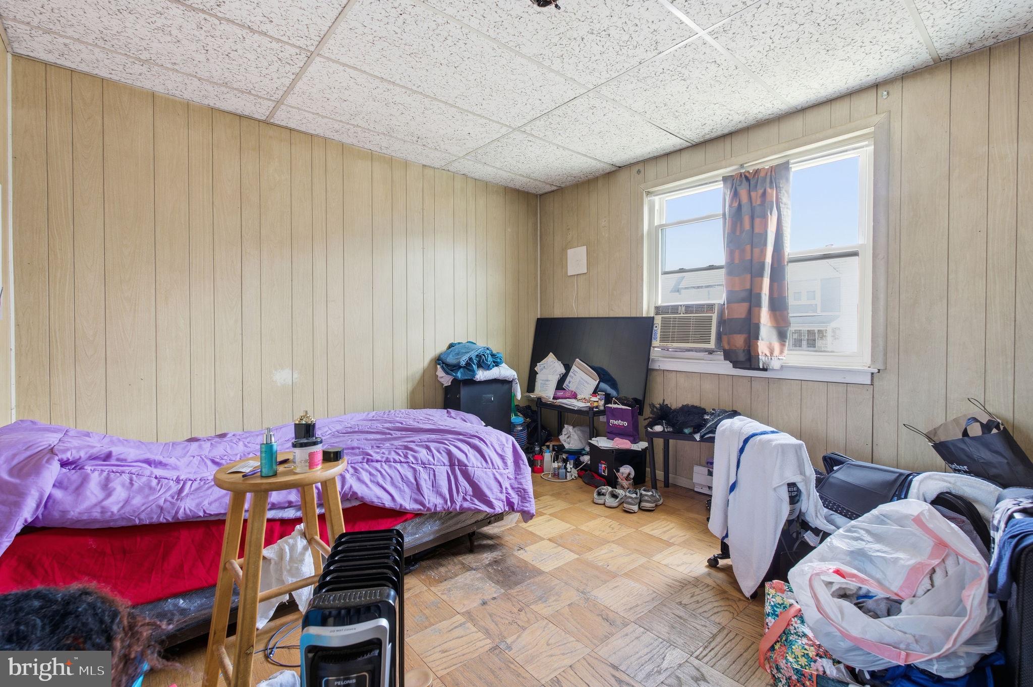 3928 8th Street Baltimore, MD 21225 - Photo 10 of 20 a bedroom with bed and a window