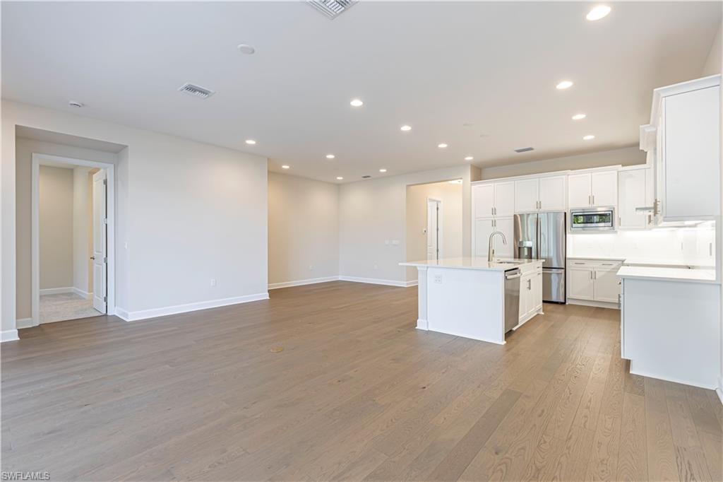 2691 Ridgecrest Place Naples, FL 34112 - Photo 27 of 27 a view of kitchen with kitchen island white cabinets and stainless steel appliances