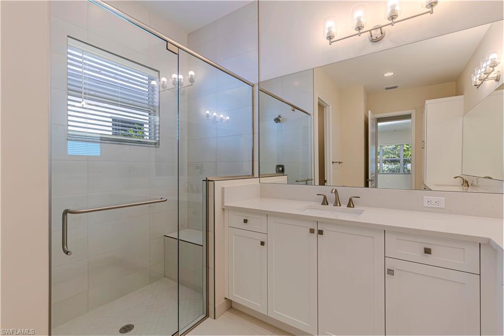 2691 Ridgecrest Place Naples, FL 34112 - Photo 19 of 27 a bathroom with a shower sink and mirror