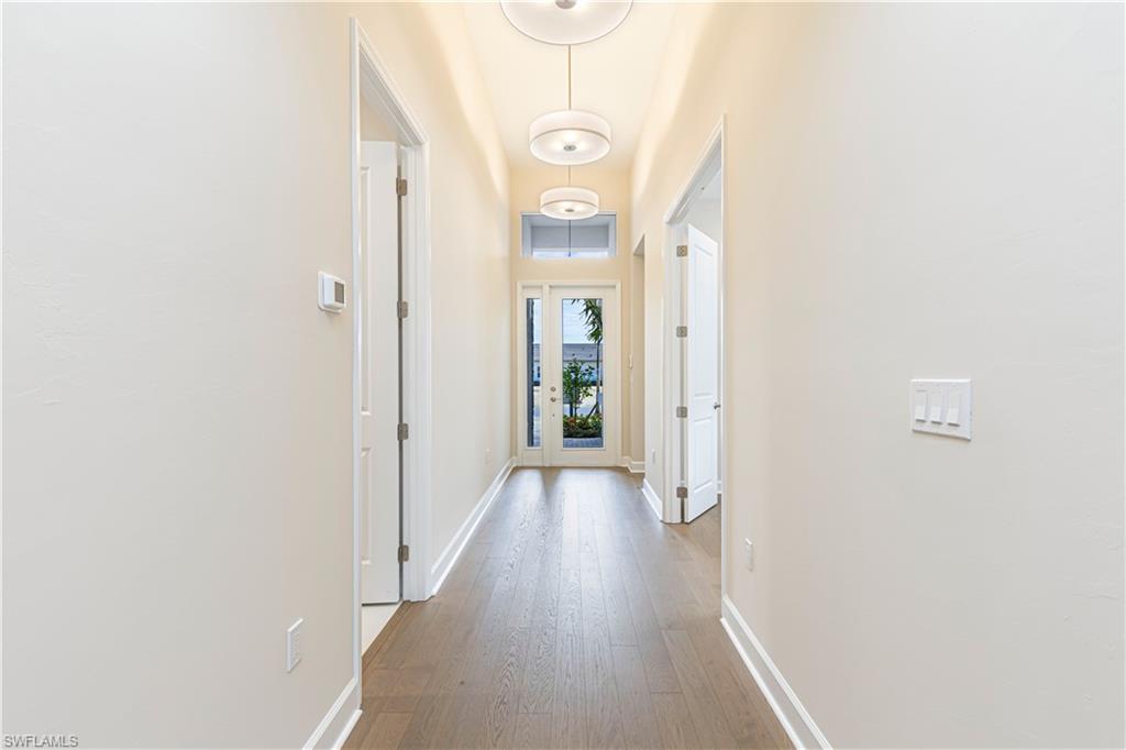 2691 Ridgecrest Place Naples, FL 34112 - Photo 20 of 27 a view of a hallway with wooden floor