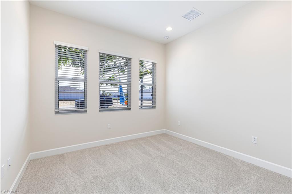 2691 Ridgecrest Place Naples, FL 34112 - Photo 5 of 27 an empty room with windows
