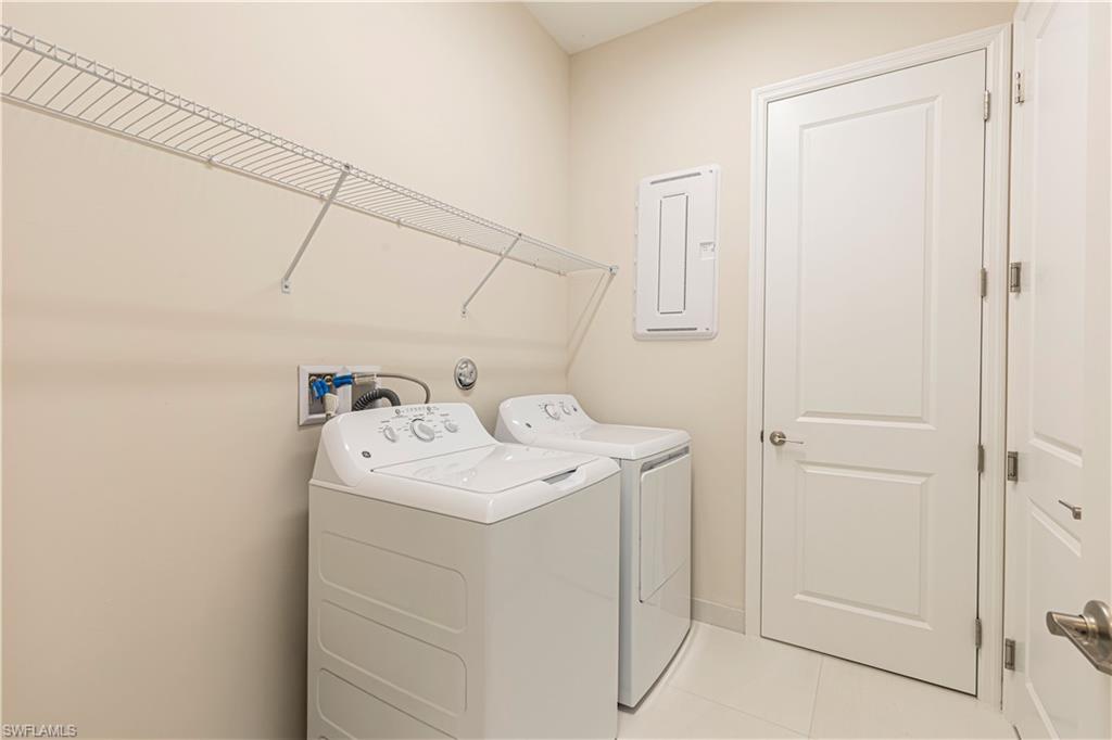 2691 Ridgecrest Place Naples, FL 34112 - Photo 8 of 27 a utility room with dryer and washer