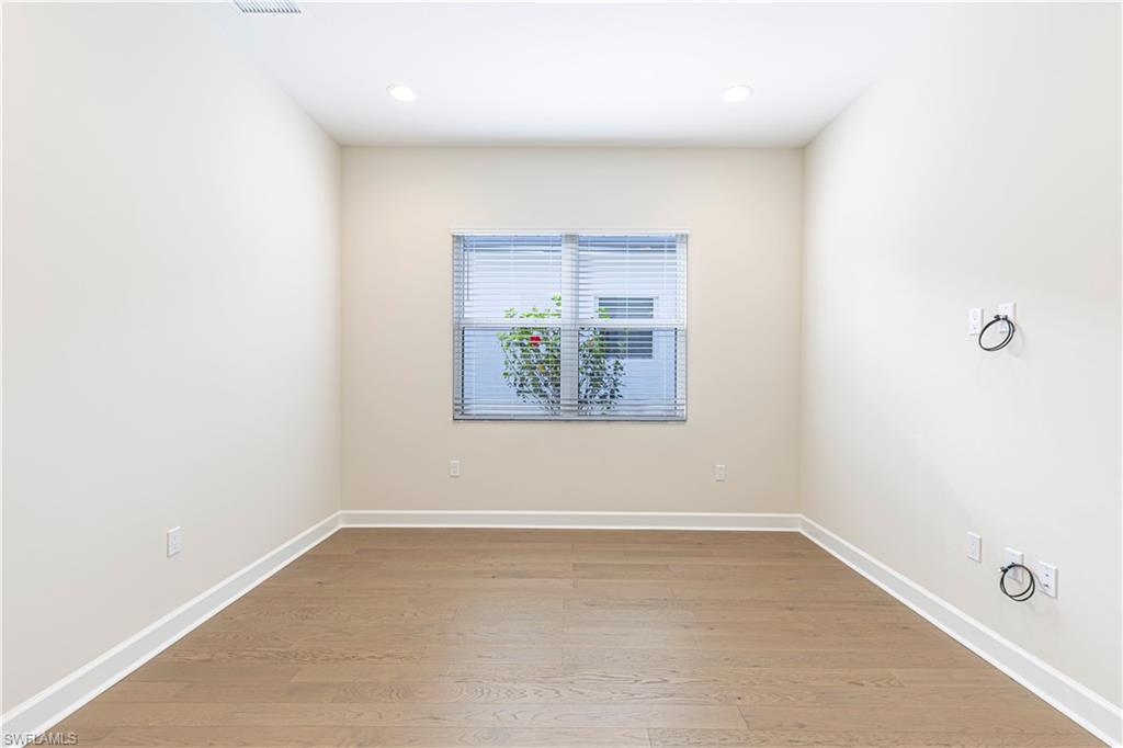 2691 Ridgecrest Place Naples, FL 34112 - Photo 9 of 27 an empty room with windows