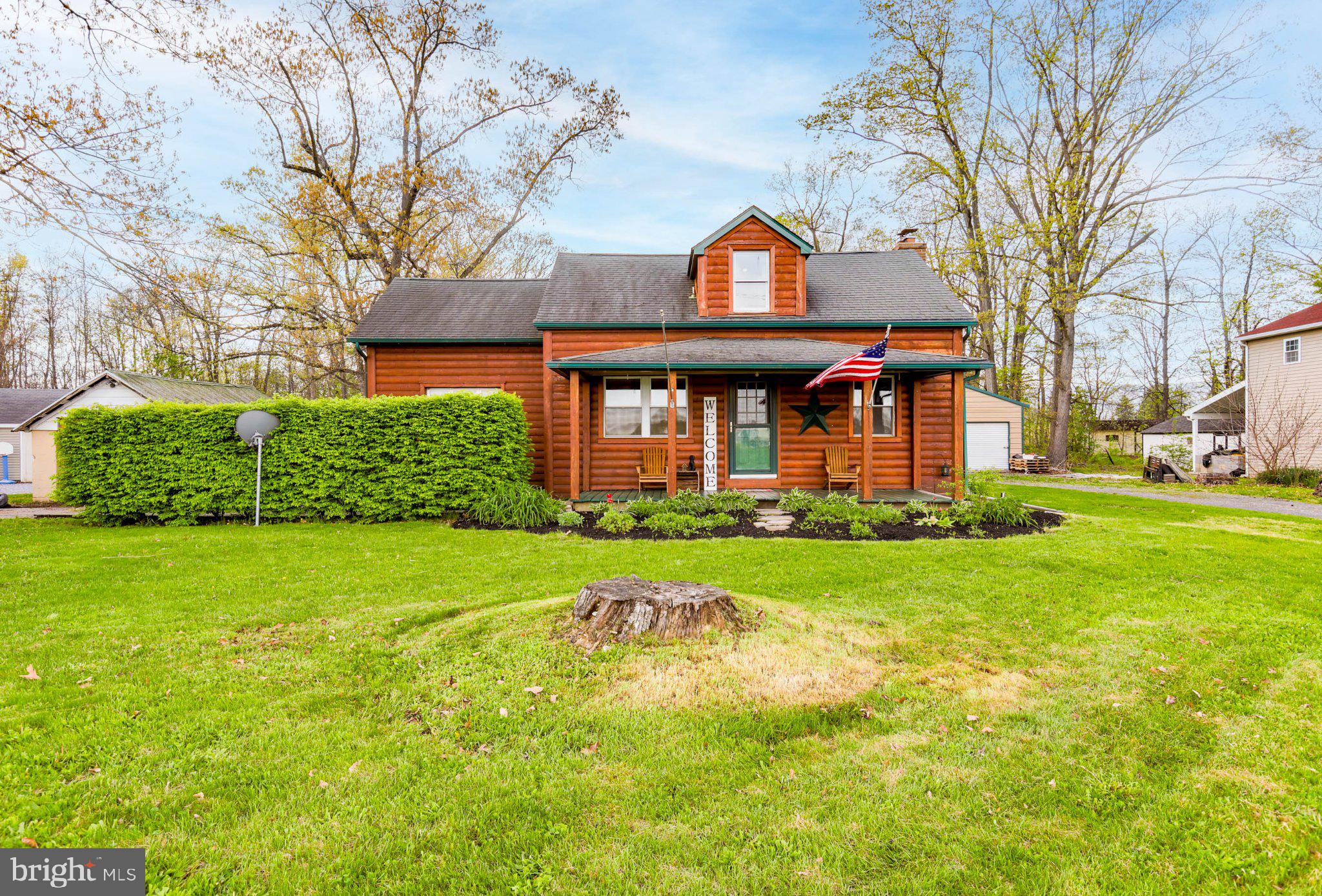 11661 Tanyard Hill Road Orrstown, PA 17244 - Photo 2 of 26 a front view of a house with a garden