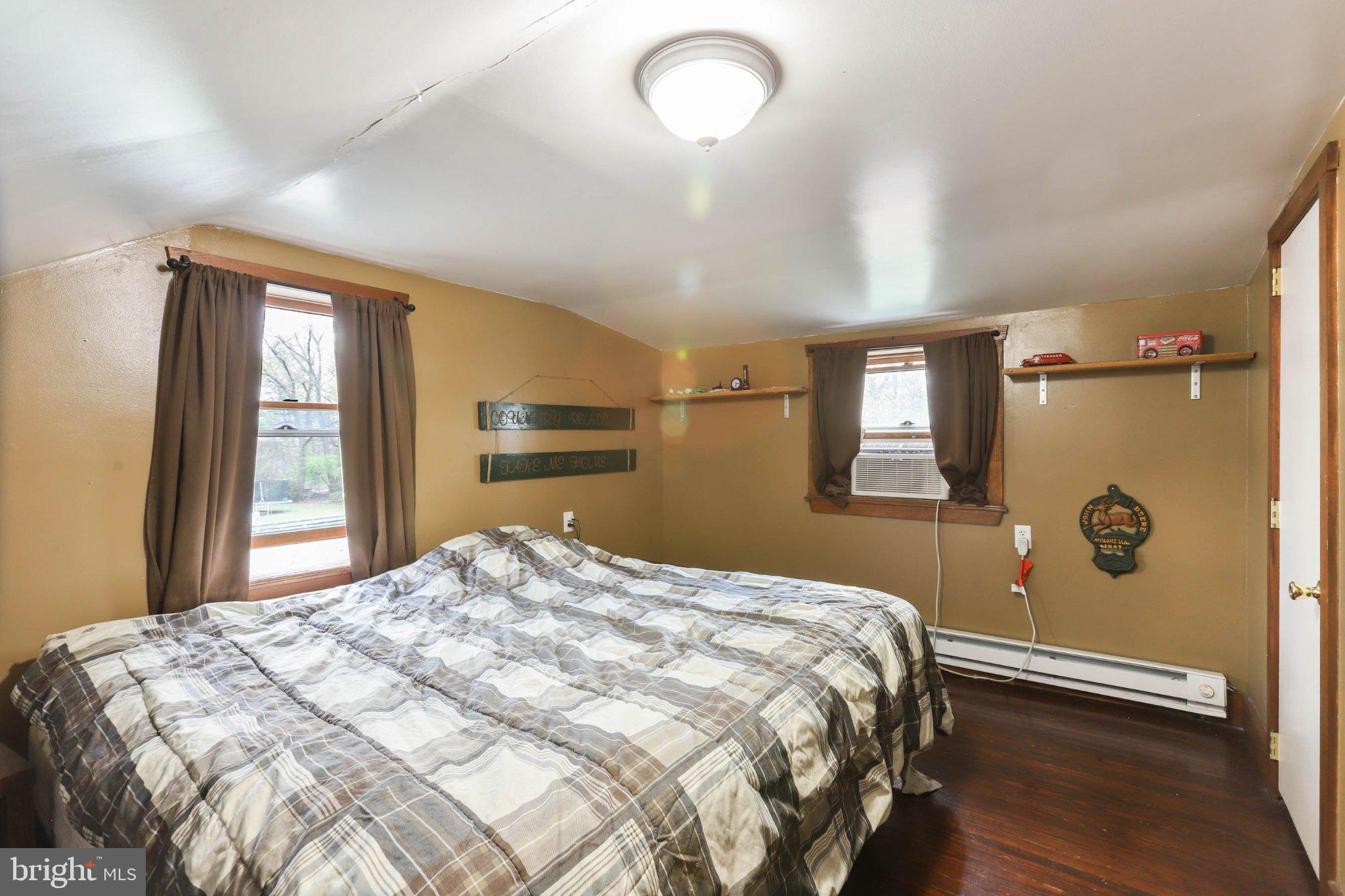 11661 Tanyard Hill Road Orrstown, PA 17244 - Photo 22 of 26 a bedroom with a large bed and a chandelier