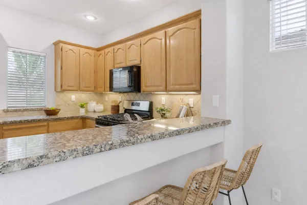 a kitchen with granite countertop a sink cabinets and window