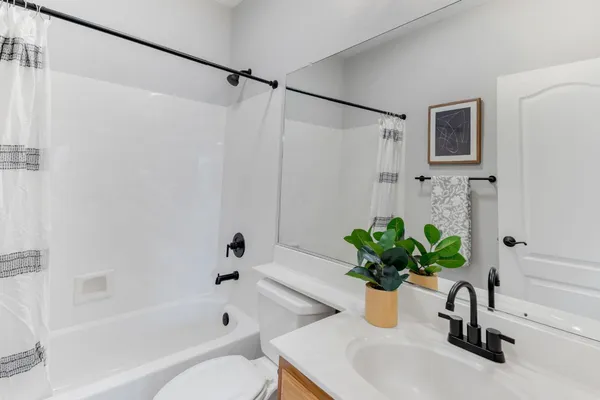 a bathroom with a sink a toilet a bathtub and shower