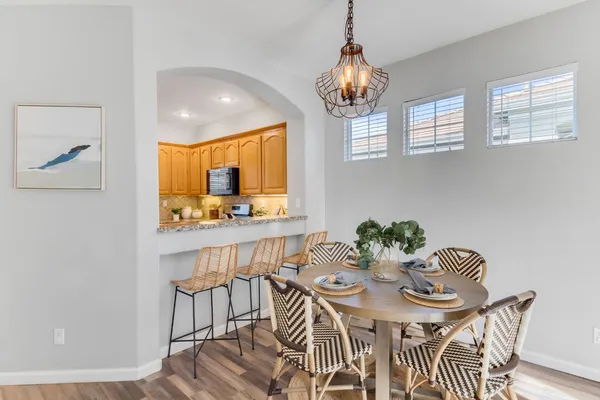 a view of a dining room with furniture and chandelier