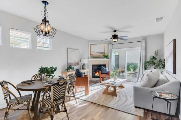 a living room with furniture a fireplace and a chandelier