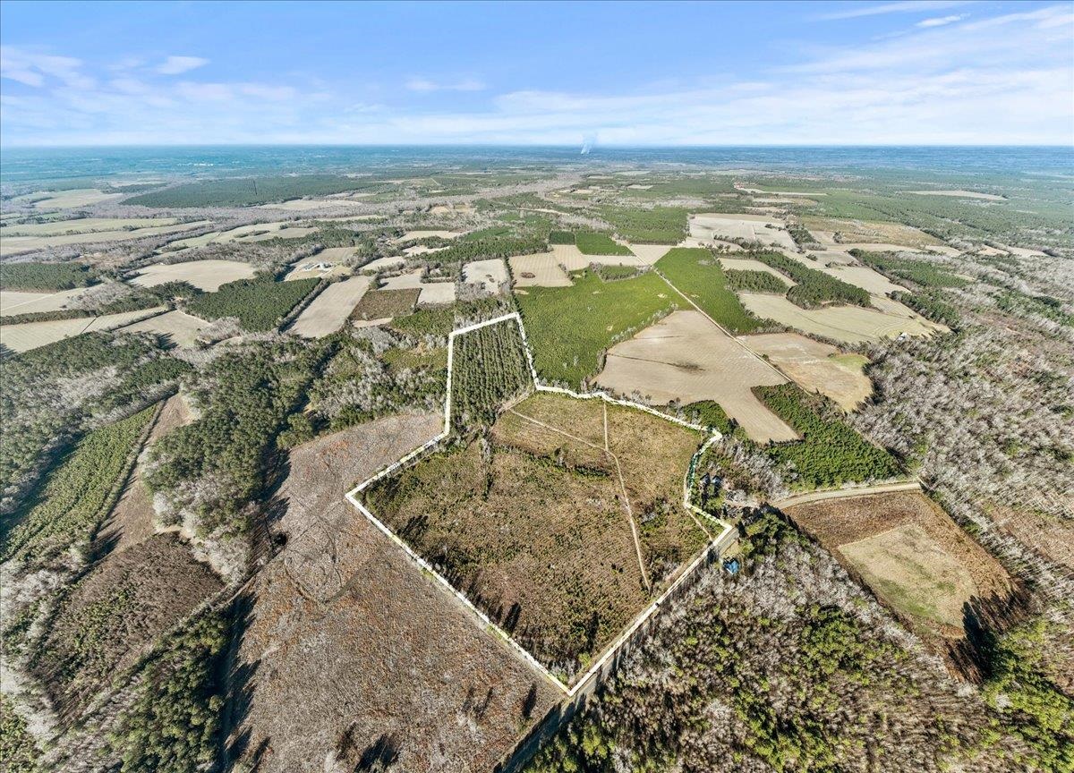 Aerial view of property's location with rows of crops and rural landscape