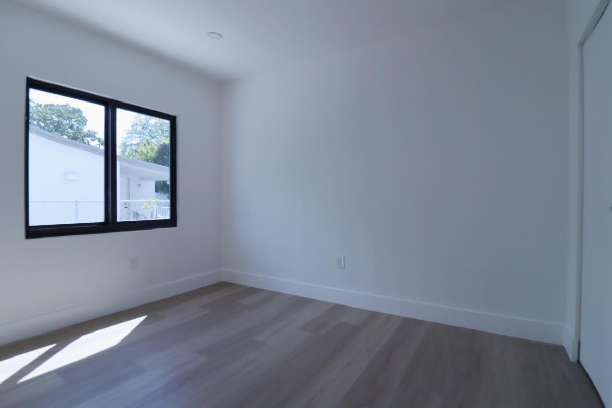 3040 Northwest 13th Avenue Miami, FL 33142 - Photo 15 of 16 an empty room with a window