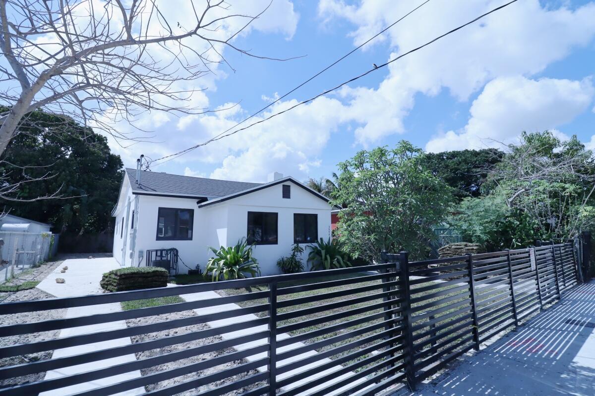 3040 Northwest 13th Avenue Miami, FL 33142 - Photo 2 of 16 a front view of a house with garden