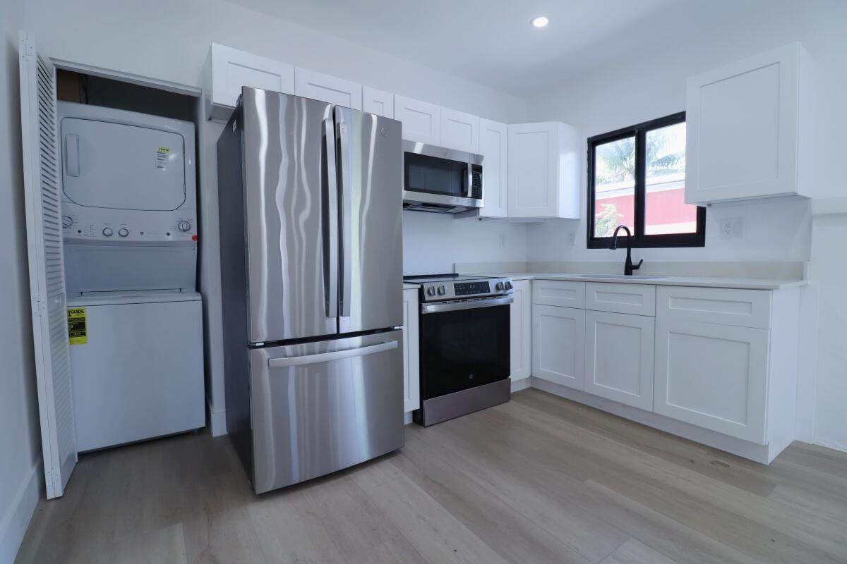 3040 Northwest 13th Avenue Miami, FL 33142 - Photo 4 of 16 a kitchen with stainless steel appliances a refrigerator sink and microwave