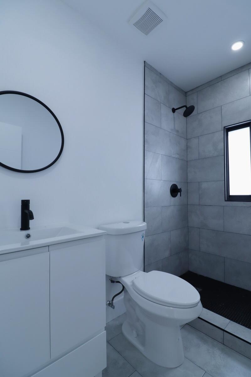 3040 Northwest 13th Avenue Miami, FL 33142 - Photo 10 of 16 a bathroom with a toilet a sink and shower