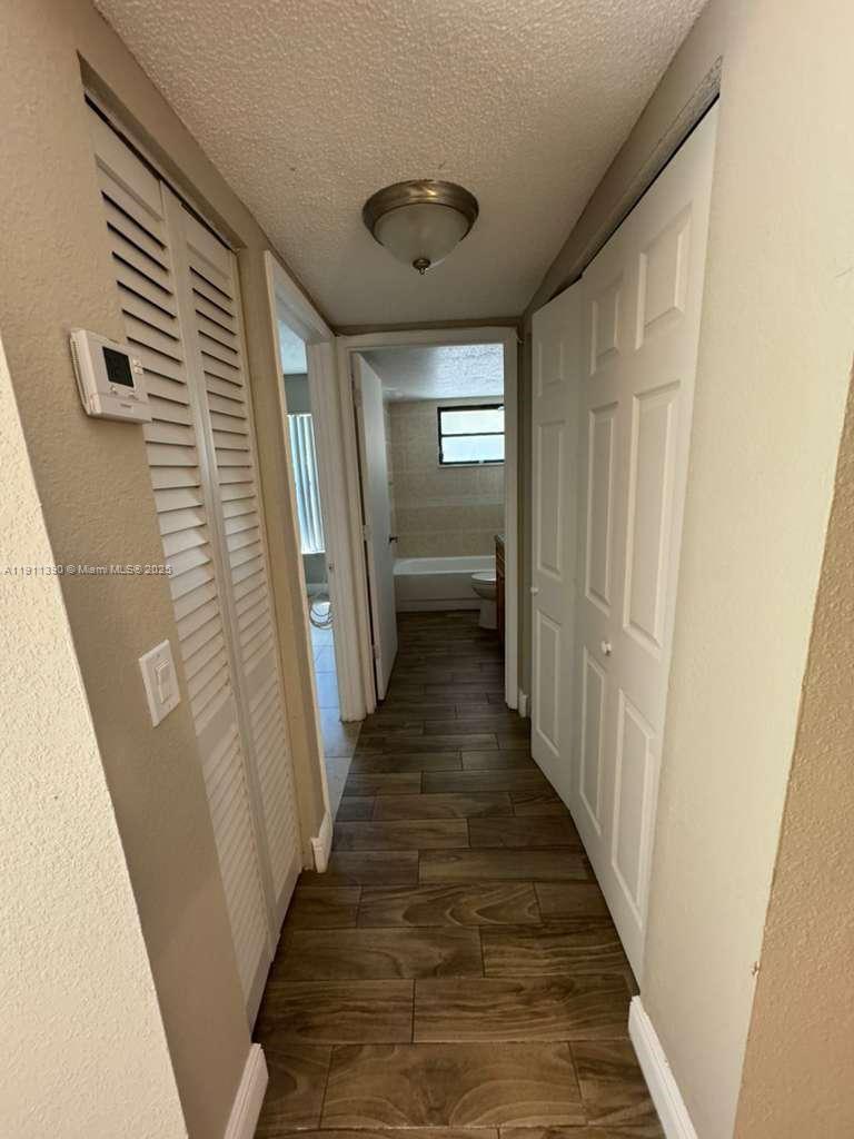 1580 Windorah Way, Unit E West Palm Beach, FL 33411 - Photo 11 of 20 a view of a hallway with wooden floor and staircase