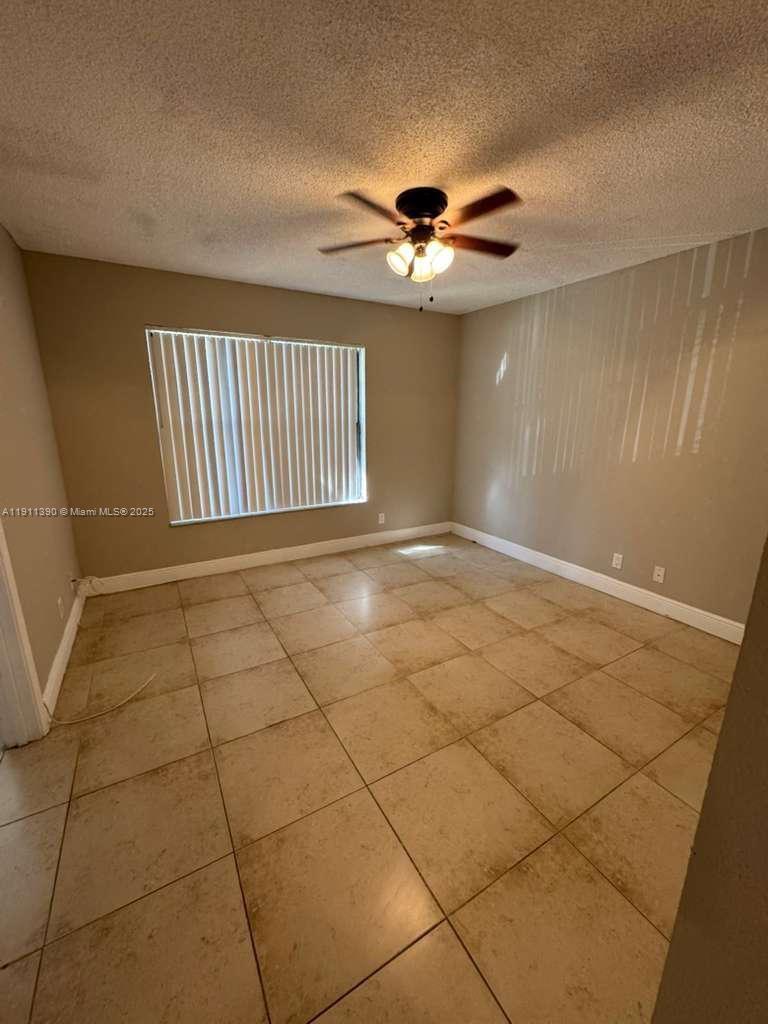 1580 Windorah Way, Unit E West Palm Beach, FL 33411 - Photo 12 of 20 a view of an empty room with a window