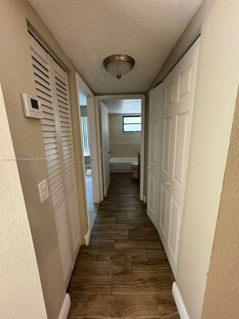 1580 Windorah Way, Unit E West Palm Beach, FL 33411 - Photo 15 of 20 a view of a hallway with wooden floor and staircase