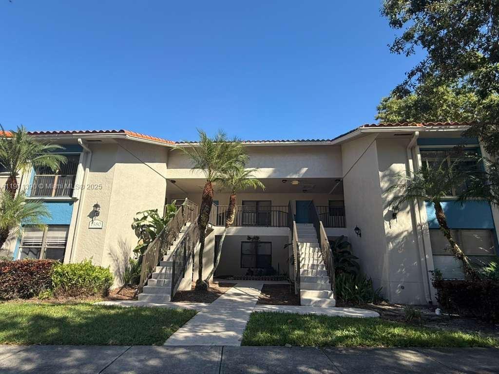 1580 Windorah Way, Unit E West Palm Beach, FL 33411 - Photo 2 of 20 a front view of a house with a yard