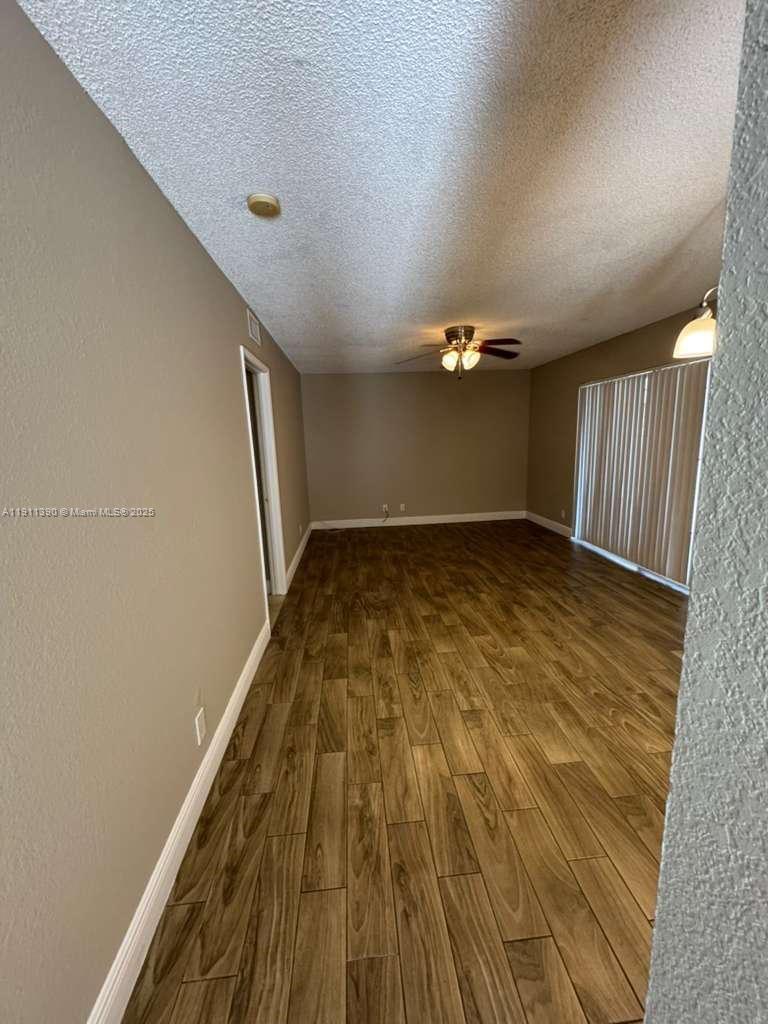 1580 Windorah Way, Unit E West Palm Beach, FL 33411 - Photo 8 of 20 a view of empty room with wooden floor