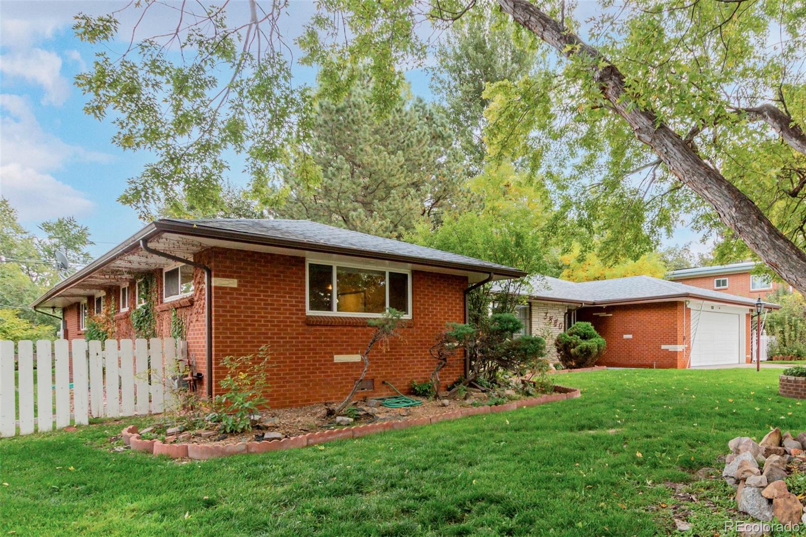 3880 Independence Court Wheat Ridge, CO 80033 - Photo 12 of 47 a front view of a house with a yard and porch