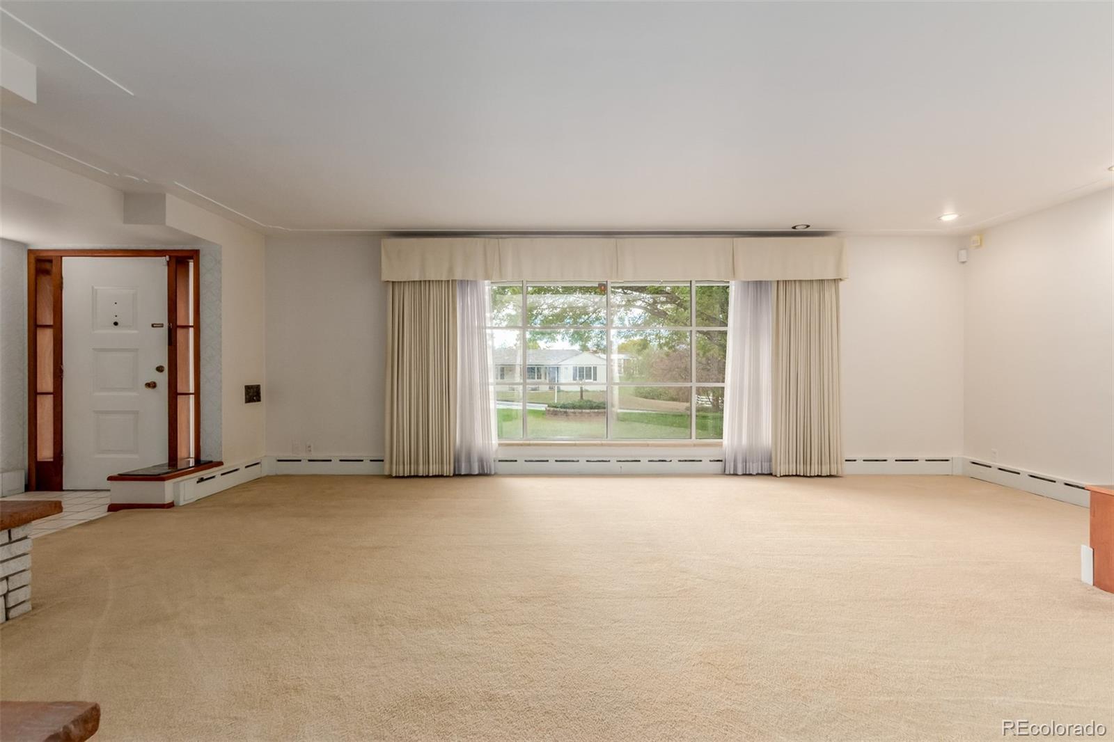 3880 Independence Court Wheat Ridge, CO 80033 - Photo 17 of 47 an empty room with a fireplace